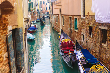 Fototapeta na wymiar Venetian channel with ancient houses and boats