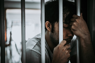 Hands of men desperate to catch the iron prison,prisoner concept,thailand people,Hope to be free.