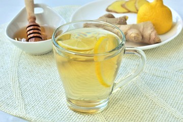 Ginger tea with honey and lemon, homemade nausea remedy.
