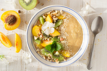 Smoothie with peach, kiwi, nuts, sesame 