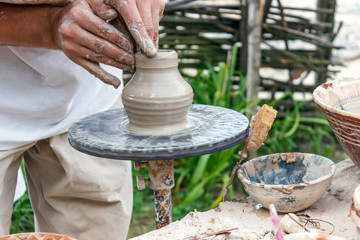 Human hands make a clay jug close-up. Sculptor's workshop. The sculptor makes a jug of clay close-up.