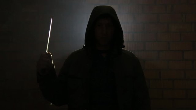 Maniac raised his hand with a knife waiting for his victim HD