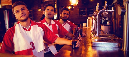 Fototapeta premium Group of male friends watching football match