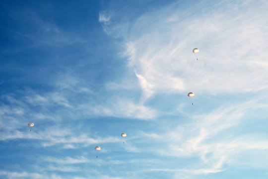 white parachutes in the sky