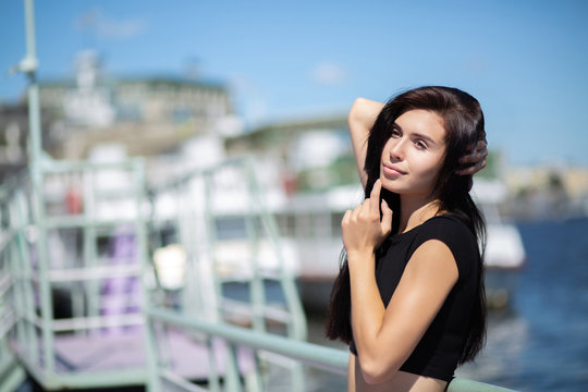 Romantic brunette model enjoying warm weather, posing at the river. Space for text © vpavlyuk