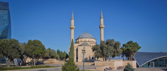 City view of the capital of Azerbaijan - Baku. Famous Flame Towers, mosque and funicular station.