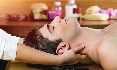Young man relaxed in spa ,Closeup of a man having head massage