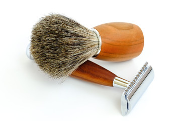 Traditional steel razor with hairy shaving brush isolated in white