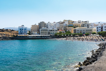Fototapeta na wymiar Agios Nikolaos. Crete. The beach on the seafront Akti PapaNikolaou Pagkalou