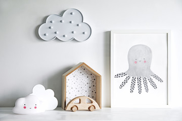 The modern scandinavian newborn baby room with mock up poster frame, wooden car and clouds....