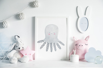Stylish scandinavian nursery interior with mock up photo frame , white rabbit, pinky pig  and star. Hanging cotton lamps and mirror on the  white background wall.