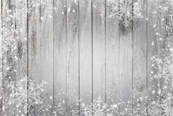 white snowflakes as a border against a wood background