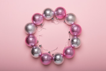 Pink and silver christmas balls on a paper background
