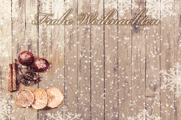 Snowflakes on a wood background as a border with Christmas fruits and the text Merry Christmas
