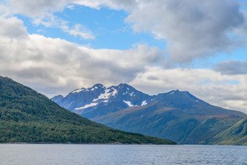 Naklejka na ściany i meble Norwegian fjords and mountains seen from the sea