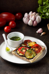 Open sandwich with eggplant, tomato, cheese and olive oil with greens and garlic. Delicious snack, homemade lunch, tasty food
