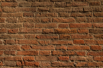 Texture of an old brick wall in contrast lighting. Natural background.
