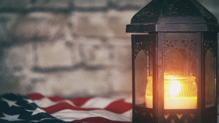 Lighted candle with an American flag, background