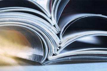 Pile of Open magazines, blue toned image