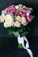 Beautiful wedding bouquet for the bride with white, rosy and purple roses