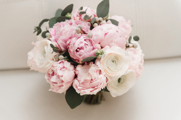 Beautiful wedding bouquet for the bride with pink peonies and white peony roses