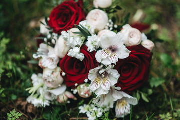 Beautiful wedding bouquet for the bride with red and white roses and eustoma