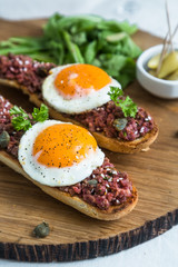 Beef tartare with pickled fried egg on top.