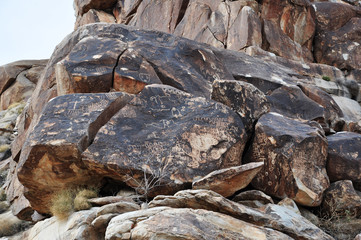 A pile of rocks with petroglyphs carved into them