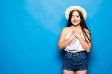 Portrait of stylish cute smiling asian girl wears straw hat posing on blue background
