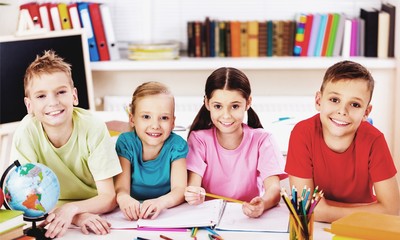 Fototapeta premium Friendly school children with books at class