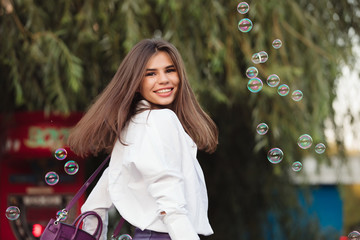 Happy girl enjoy soap bubbles