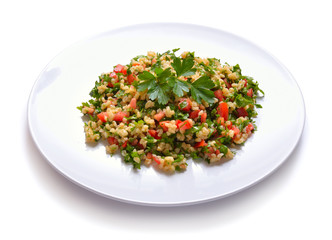 Tabbouleh salad with burghul or bulgur. On white plate