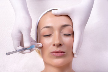 Portrait of beautiful woman during skin treatment with hyaluronic acid