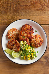 Chicken patties or  burgers with avocado corn salsa. View from above, top studio shot