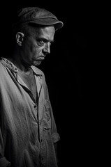 An elderly man in a cap.