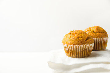 Homemade Whole Wheat Bran Carrot Muffin on White Cotton Kitchen Towel. Breakfast Morning Sunlight. Healthy Pastry Baking Concept. Minimalist Style Copy Space for Text