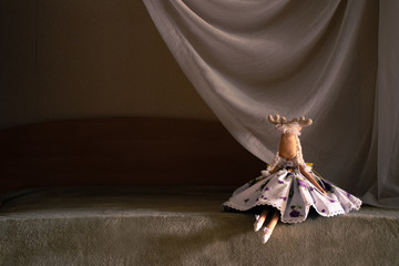 The toy dancer sits at the 'scene'. Self-made toy deer. Dressed in dancer clothes