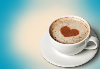 Coffee with heart shaped foam on wooden background