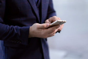 Phone in the hands of a businessman businessman in a business suit.