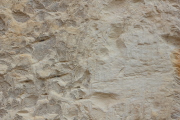 Texture of a stone wall. Vintage background. A wall of medieval buildings. Abstract pattern with a natural material. Blank for design