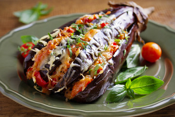 Baked eggplant, stuffed with meat, tomatoes, paprika, onion and cheese. Aubergine with meat and vegetables