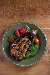 Baked eggplant, stuffed with meat, tomatoes, paprika, onion and cheese. Aubergine with meat and vegetables