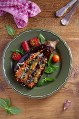 Baked eggplant, stuffed with meat, tomatoes, paprika, onion and cheese. Aubergine with meat and vegetables