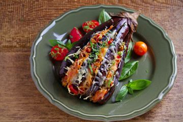 Baked eggplant, stuffed with meat, tomatoes, paprika, onion and cheese. Aubergine with meat and vegetables