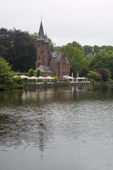 Fototapeta na wymiar Minnewater castle at the Lake of Love in Bruges, Belgium