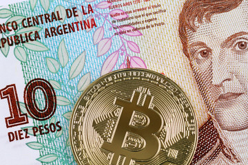 A macro image of a golden bitcoin with a ten peso Argentinian bill in macro