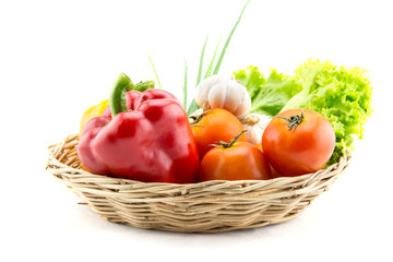 Fototapeta na wymiar Organic vegetables in the wicker basket on white background