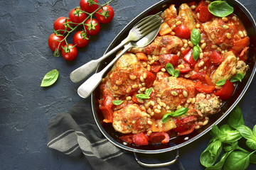 Chicken stewed with bell pepper and white bean in a tomato sauce.Top view.