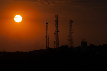 Naklejka premium communication towers in the sunset