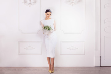 Elegant woman in short fashionable bridal dress